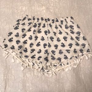 Small frayed blue & white floral print shorts.